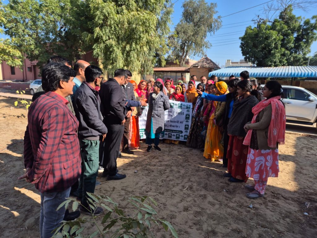 Rural women SHG members holding the SGJSS NABARD exposure visit banner, Bikaner, Rajasthan