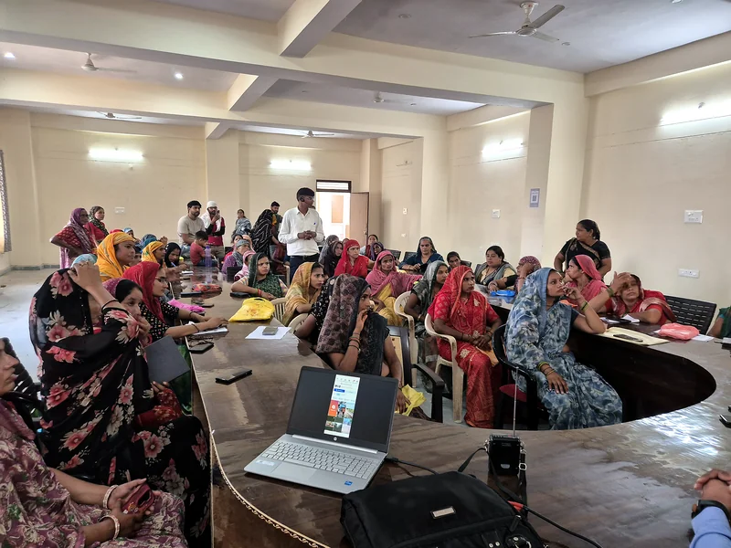Hands-on e-commerce training session for SHG women with laptop demonstration at Uchchain, Bharatpur, June 2026.